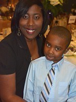 An African-American woman and her son smile for the camera